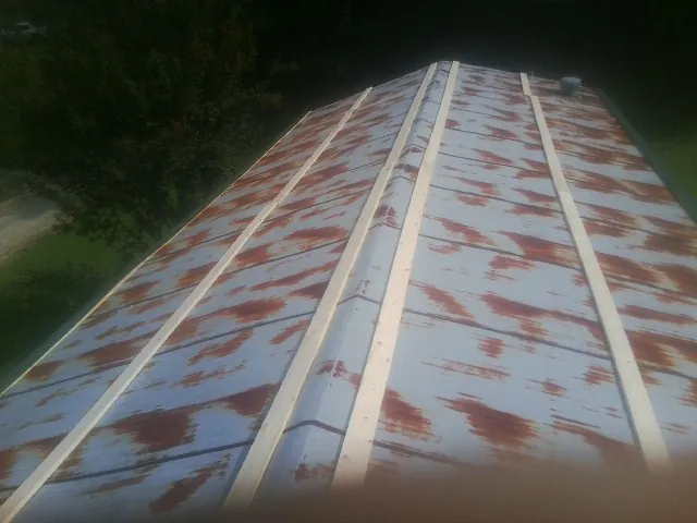Rusted metal roof panels with new wood purlins before replacement — Storm Damage Roof Repair in Ottsville by Roofing Brothers