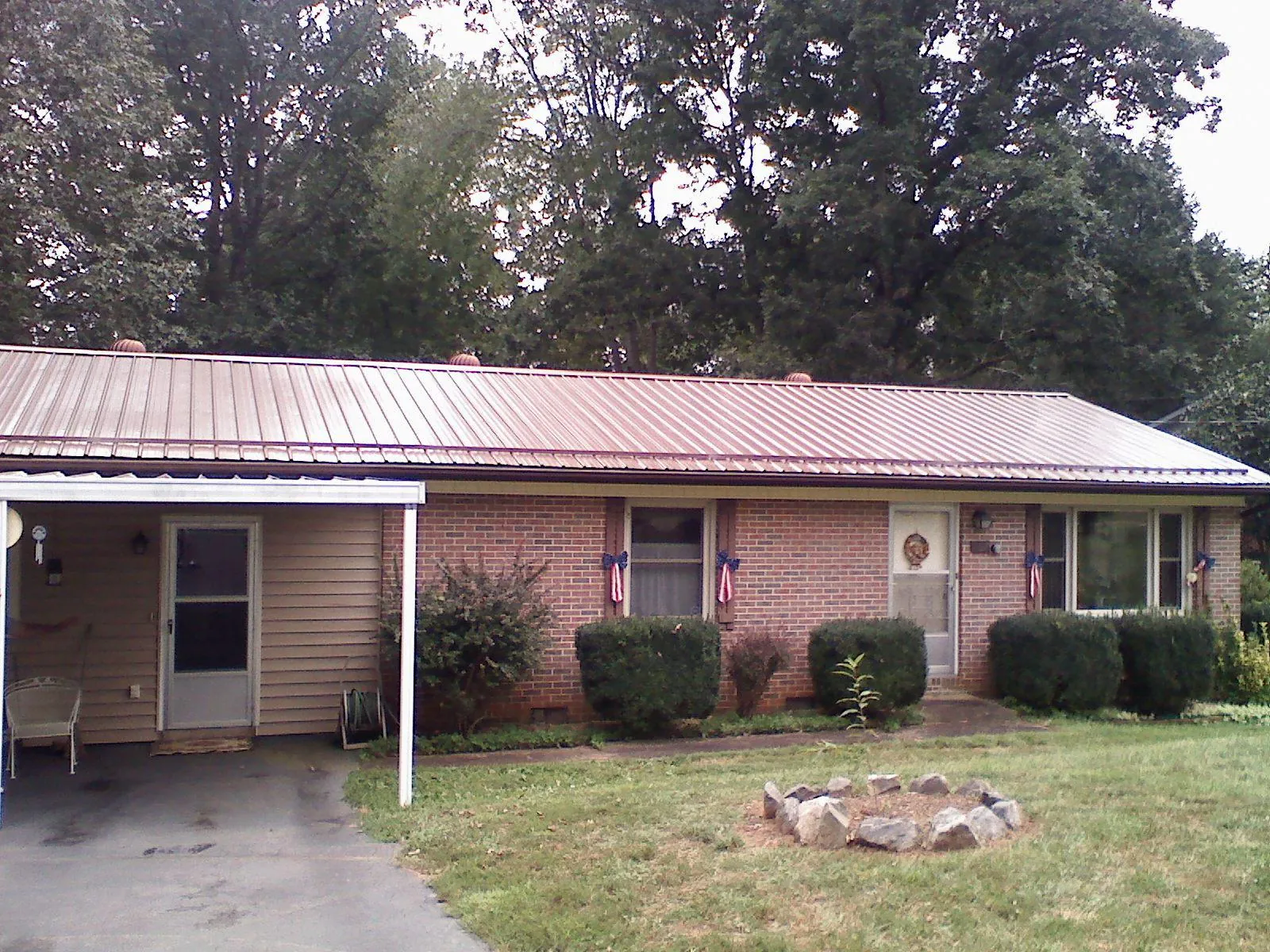 Bronze metal roof and carport on a brick ranch home — Roof Repair work by our crew in Ottsville